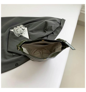 Top view of deep green oily leather bag interior with magnetic buckle and fabric lining