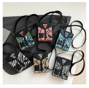 Detail view of stylish suit-inspired crossbody bags featuring tie designs and animal prints