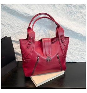 Detailed macro shot of the red PU tote bag featuring lychee texture and silver hardware