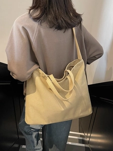 Large beige canvas tote bag for commuting, minimalist shoulder and crossbody style