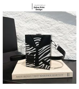 Detail of zebra print box bag featuring a creative tie design and silver metal hooks