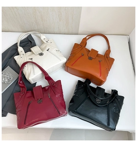 Detail of four multi-functional PU tote bags in ivory, orange, wine red, and black colors