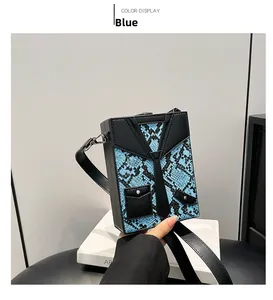 Detailed view of blue python texture box bag with creative tie and suit lapel design