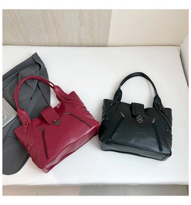 Detail of PU leather tote bags showing lychee texture and floral metal buckle accents