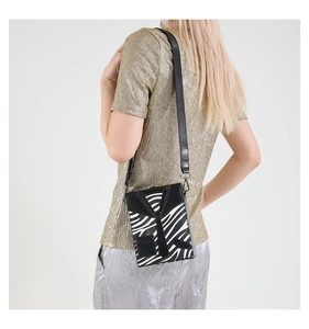 Detail of the zebra pattern shoulder bag featuring a unique suit and tie design element
