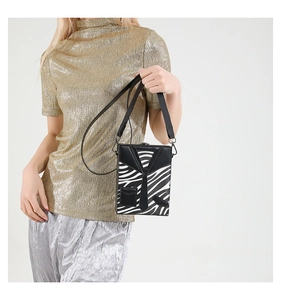 Detail view of square crossbody bag with zebra print and creative suit tie design