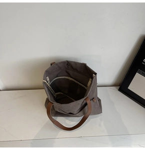 Internal view of canvas tote bag with side pocket and secure magnetic button closure