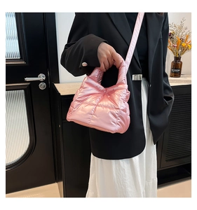 Close-up of pearl pink quilted puffy tote bag with metallic finish and soft texture