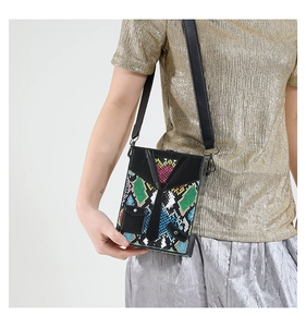 Detail view of colorful snake skin pattern box bag with creative suit and tie design