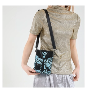 Detail of crossbody box bag featuring blue snake skin texture and suit tie 3D design