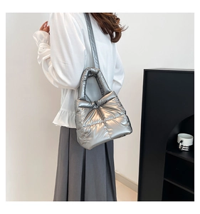 Detail of silver puffy tote bag with metallic finish and soft down-cotton padding material