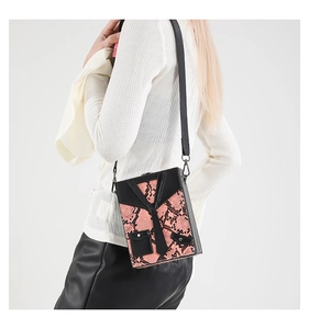 Detail view of the pink snake print box bag with black suit collar and tie design