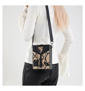 Detail of creative suit-style hard shell crossbody bag with beige snakeskin texture