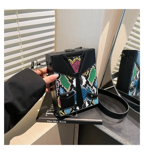 Detailed view of hardshell box bag featuring a tie-design and multi-color python print