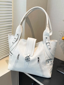 Elegant white faux leather tote bag with decorative zippers and floral metal ornament