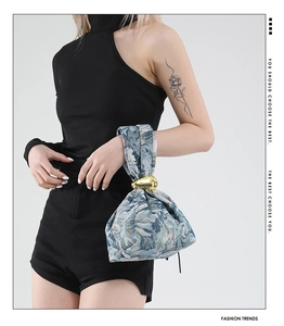 Detailed view of zebra pattern jacquard handbag with elegant gold metal ring handle detail