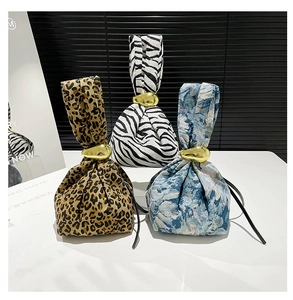 Detailed view of stylish zebra and leopard print wristlet bags with gold ring accents