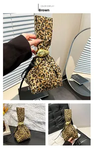Detail view of brown leopard print handbag featuring a unique gold teardrop metal buckle