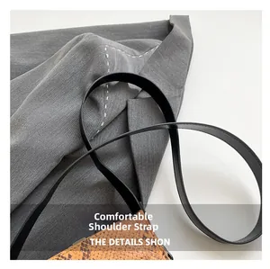 Detail of faux python texture crossbody bag with sleek black leather shoulder strap