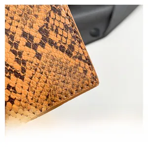 Detailed macro view showing the snakeskin texture and fine stitching of this crossbody bag