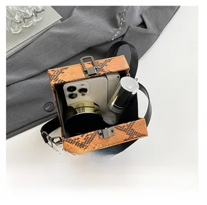 Detailed top view of snake pattern handbag showing capacity for phone and cosmetics