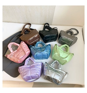 Quilted puffer bucket bag displayed in eight metallic colors with adjustable straps