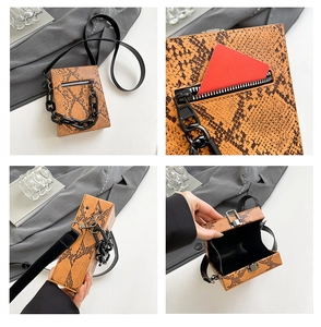 Detail view of orange snakeskin crossbody bag with decorative chain and metallic buckle