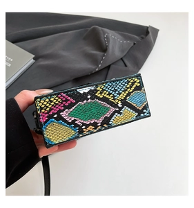 Detail view of colorful python skin texture on a structured rectangular box bag
