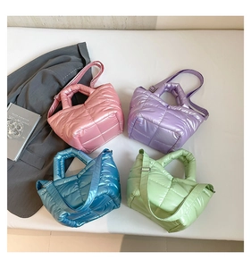 Flat lay of colorful quilted down tote bags in pink, purple, blue, and green colors