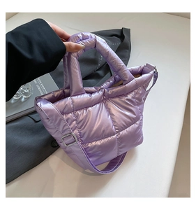 Detail shot of purple quilted down tote bag with nylon texture and adjustable strap
