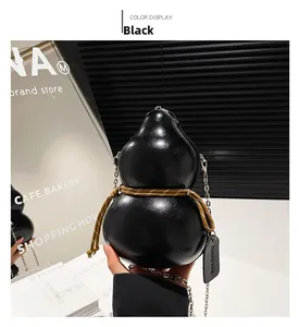 Detail of creative black gourd shaped crossbody bag with yellow rope and metallic chain