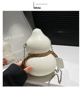 Detailed view of a white gourd-shaped crossbody bag with glossy finish and chain strap