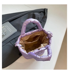 Detailed view of purple padded tote bag interior with zipper pocket and button closure