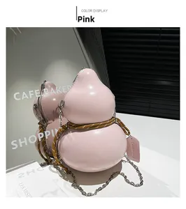 Detailed mirror view of a pink gourd-shaped crossbody bag with a silver chain strap