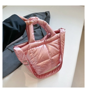 Detailed side view of pink quilted down puffer tote bag with metallic nylon finish