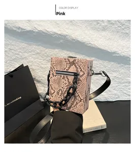 Detailed view of pink snake pattern crossbody bag with thick black chain and metal zipper