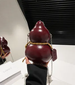 Detailed close-up of a wine red gourd-shaped crossbody bag with a silver chain strap