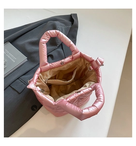 Detailed interior of a pink padded tote bag showing main compartment and zipper pocket