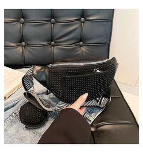 Detailed macro view of black rhinestone waist bag with stylish striped woven shoulder strap