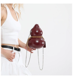 Close-up of a burgundy gourd-shaped crossbody bag with woven cord and chain strap