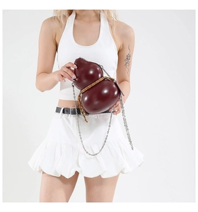 Detail of creative gourd-shaped crossbody bag in wine red glossy leather and chain