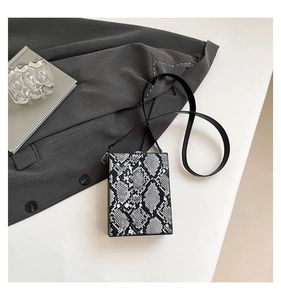 Detailed close-up of a square box bag featuring grey and black snakeskin texture