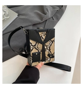 Close-up of the creative suit tie design and snake pattern on the hard shell box bag