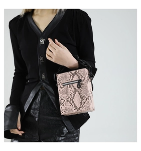 Pink faux leather square bag featuring a black snake print and chunky metal chain