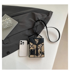 Detail of creative suit collar design on snakeskin pattern leather crossbody box bag