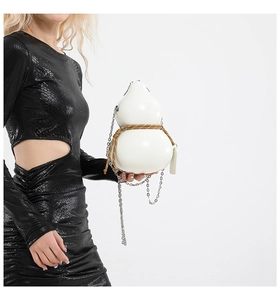 Close-up of a white gourd-shaped crossbody bag with woven rope and silver chain strap