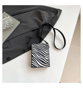 Detail shot of mini box crossbody bag featuring a stylish black and white zebra pattern