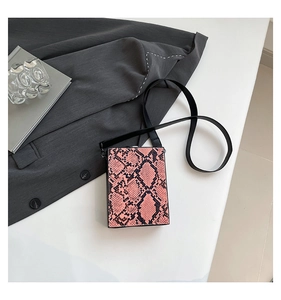 Detailed top view of a pink and black python print hardshell mini box crossbody bag