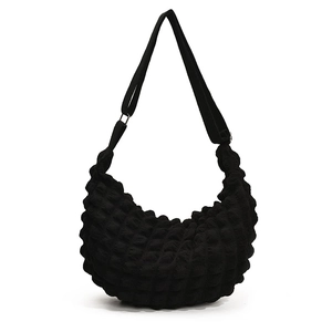 Minimalist black puff hobo bag with textured popcorn fabric and adjustable strap