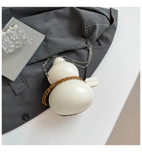 Detail of creative gourd-shaped crossbody bag in cream leather with woven rope and chain